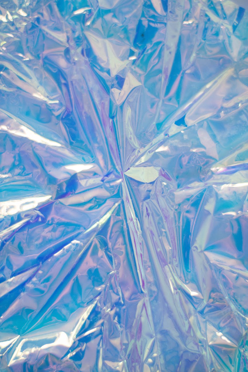 Abstract iridescent blue foil texture ideal for vibrant and artistic backgrounds.